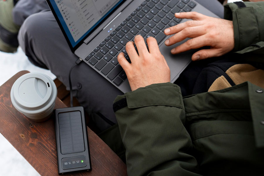 Photo of someone outdoors using a laptop